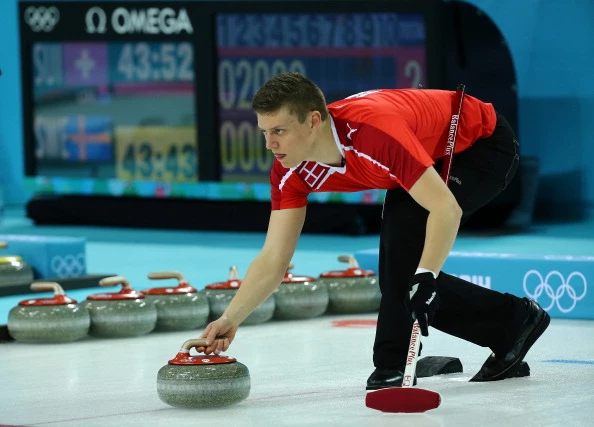 Troels Harry of Denmark releases a stone during the Men's Curling Round Robin match between Russia and Great Britain on day 3 of the Sochi 2014 Winter Olympics Troels Harry of Denmark releases a stone during the Men's Curling Round Robin match between Russia and Great Britain on day 3 of the Sochi 2014 Winter Olympics