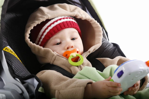 Baby in car seat with toy